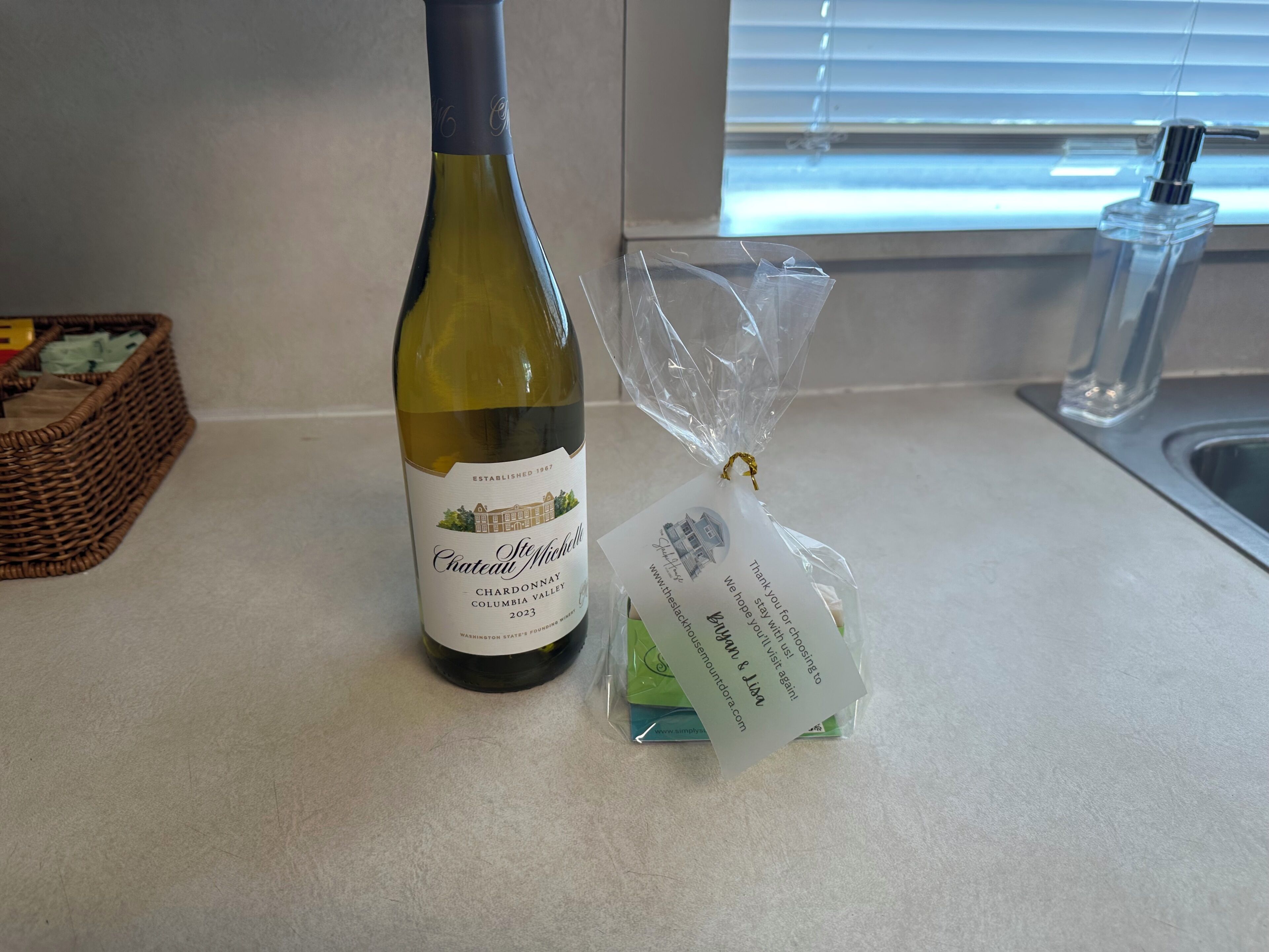 A bottle of Chateau Ste. Michelle Chardonnay 2023 on a kitchen counter.
