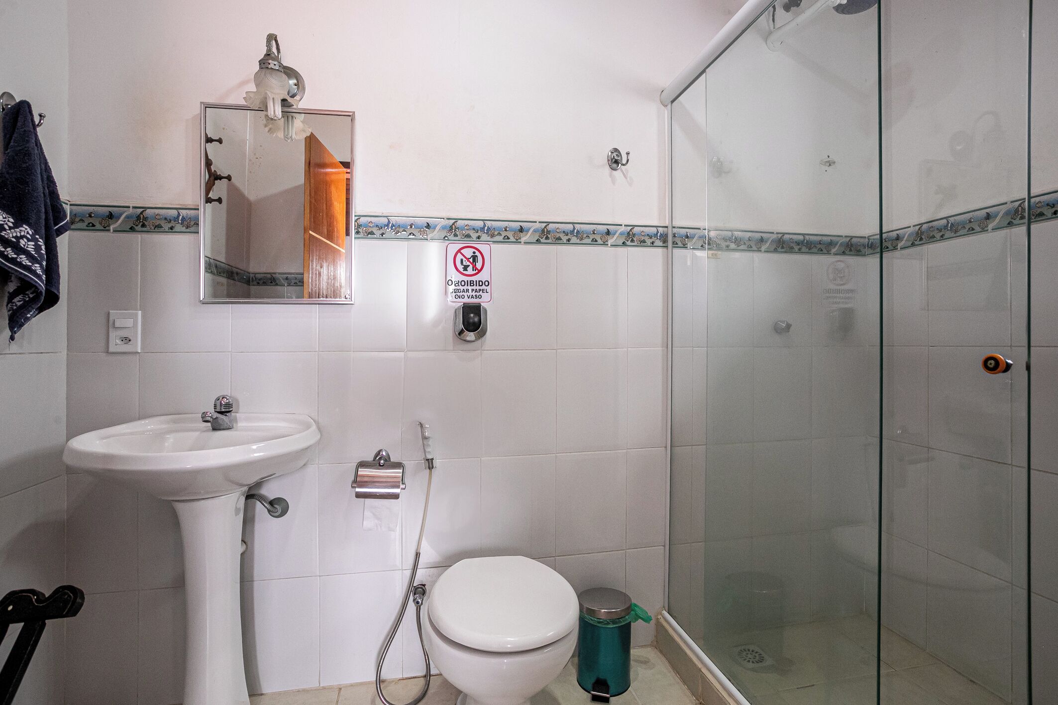 A bathroom with a sink, toilet, and glass shower enclosure.