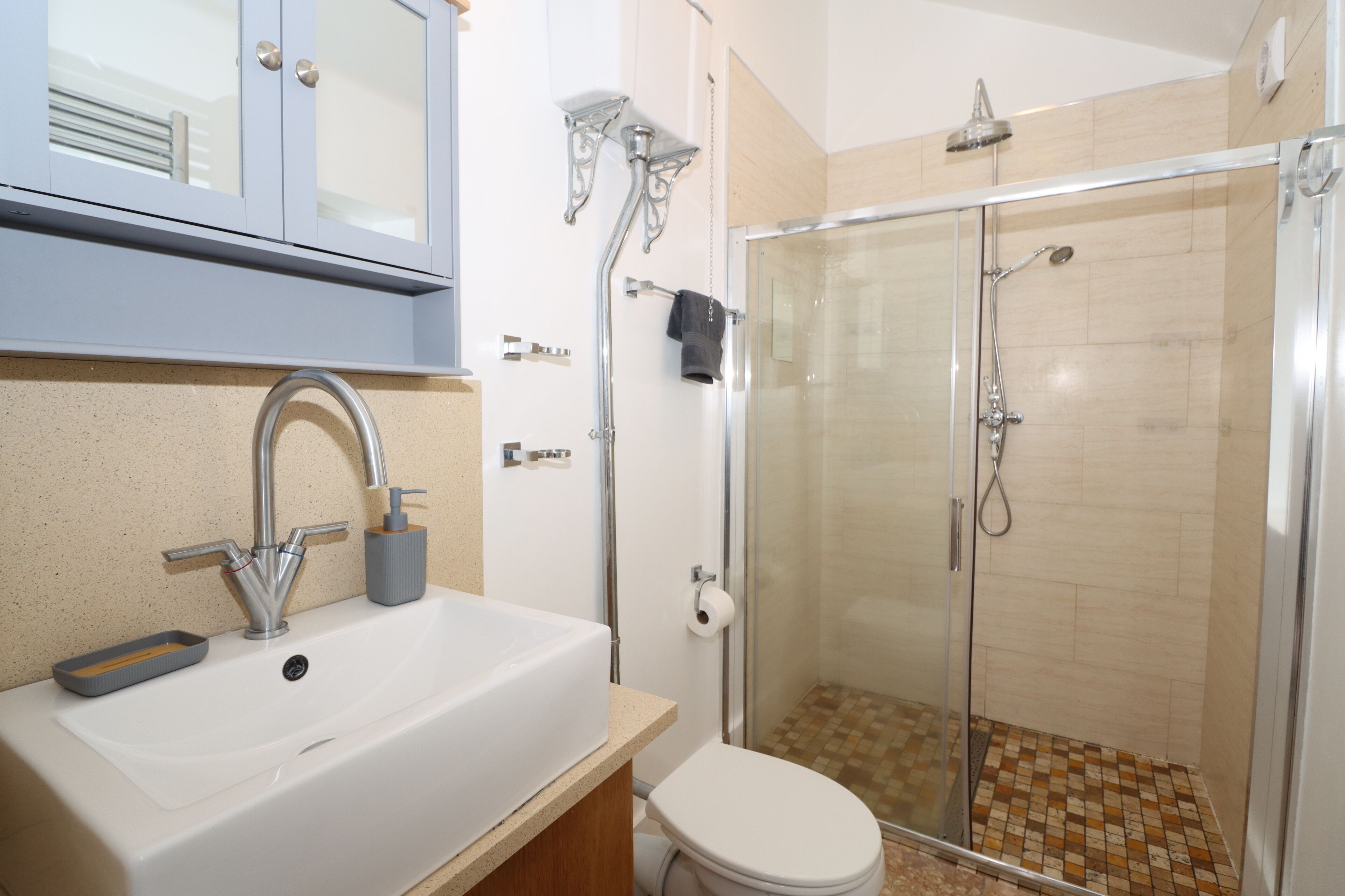 Shower, hair dryer, towels, toilet paper