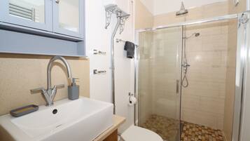 Shower, hair dryer, towels, toilet paper