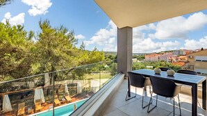 A balcony with a pool, outdoor seating, and a view of a town. - Awesome home in Pula with private swimming pool, can be inside or outside (Pula)