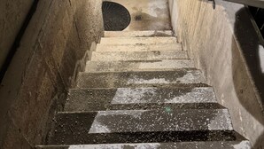 A concrete stairwell with metal railings and a handrail. - Stay cool in Basement apartment close to Mountain Trails (Sandy)