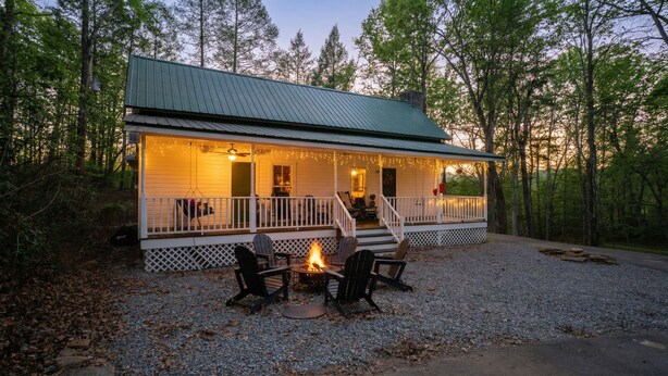 A house with a porch, outdoor seating, and a fire pit. - Special Price! Charming 4-bedroom Farmhouse w/Hot Tub in Peaceful Wears Valley (Sevierville)