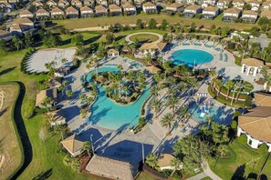 An aerial view of a resort with multiple swimming pools, palm trees, and a well-maintained lawn. - Guest favorite! Near Disney *Early check in (Four Corners)