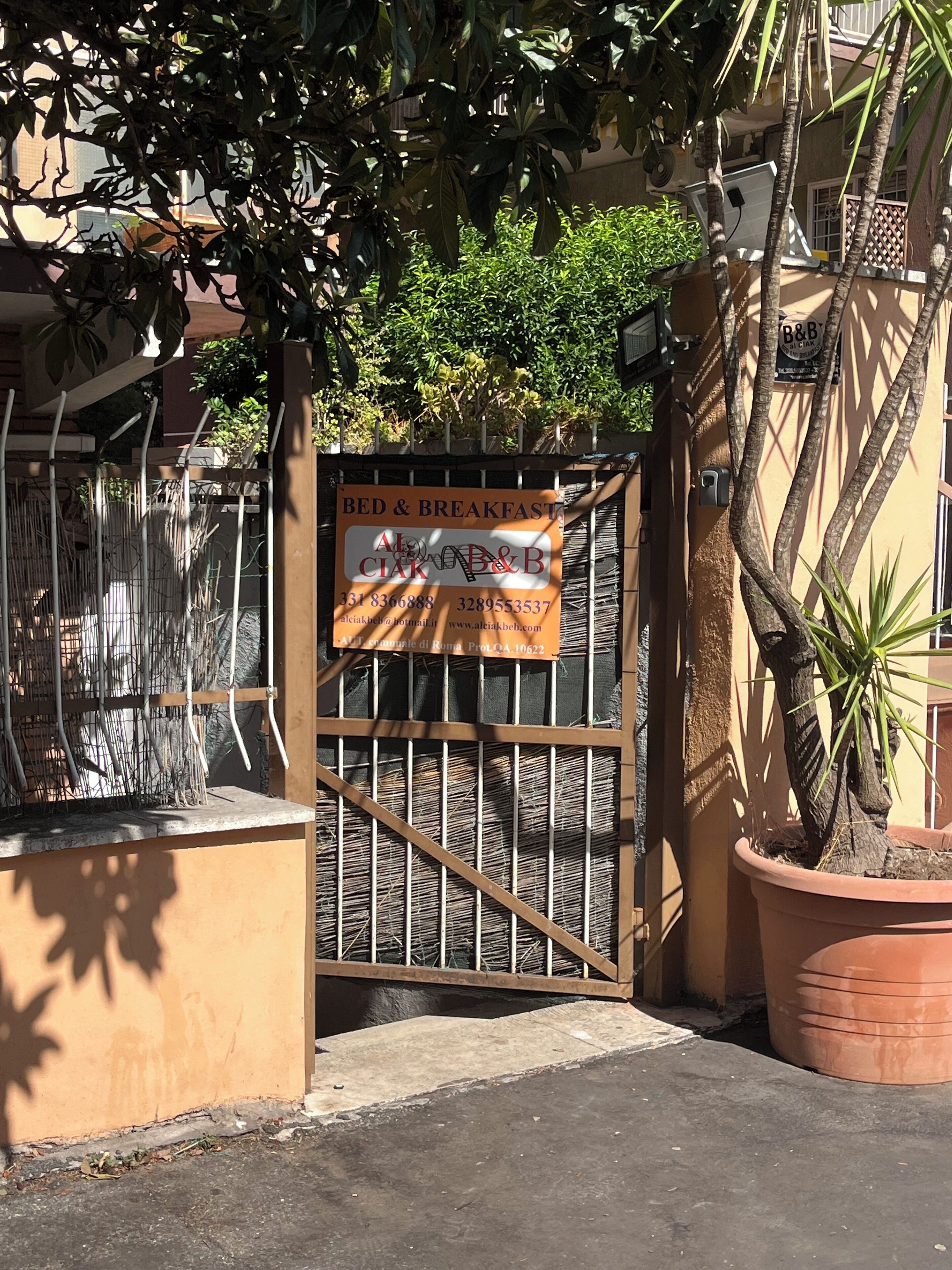 A gated entrance with a sign for a bed and breakfast.