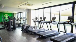 Een sportschool met loopbanden, elliptische trainers en gewichtstoestellen.