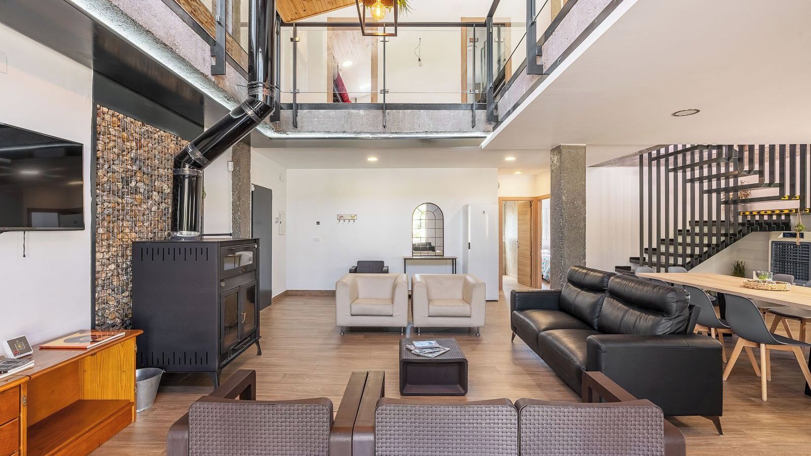 A spacious living area with a fireplace, seating, and a dining area.