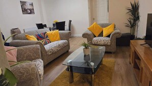A living room with two sofas, a coffee table, and a television. - Garden - Pets - Parking - Wifi - Sleeps 2 (Ashford)