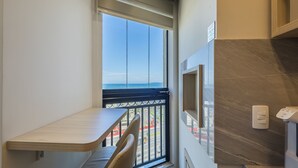 A balcony with a view of the city, a small table, and a chair. - Fully Equipped Apartments With a Prime Location 600 m From Itapema Beach Lprs (Itapema)