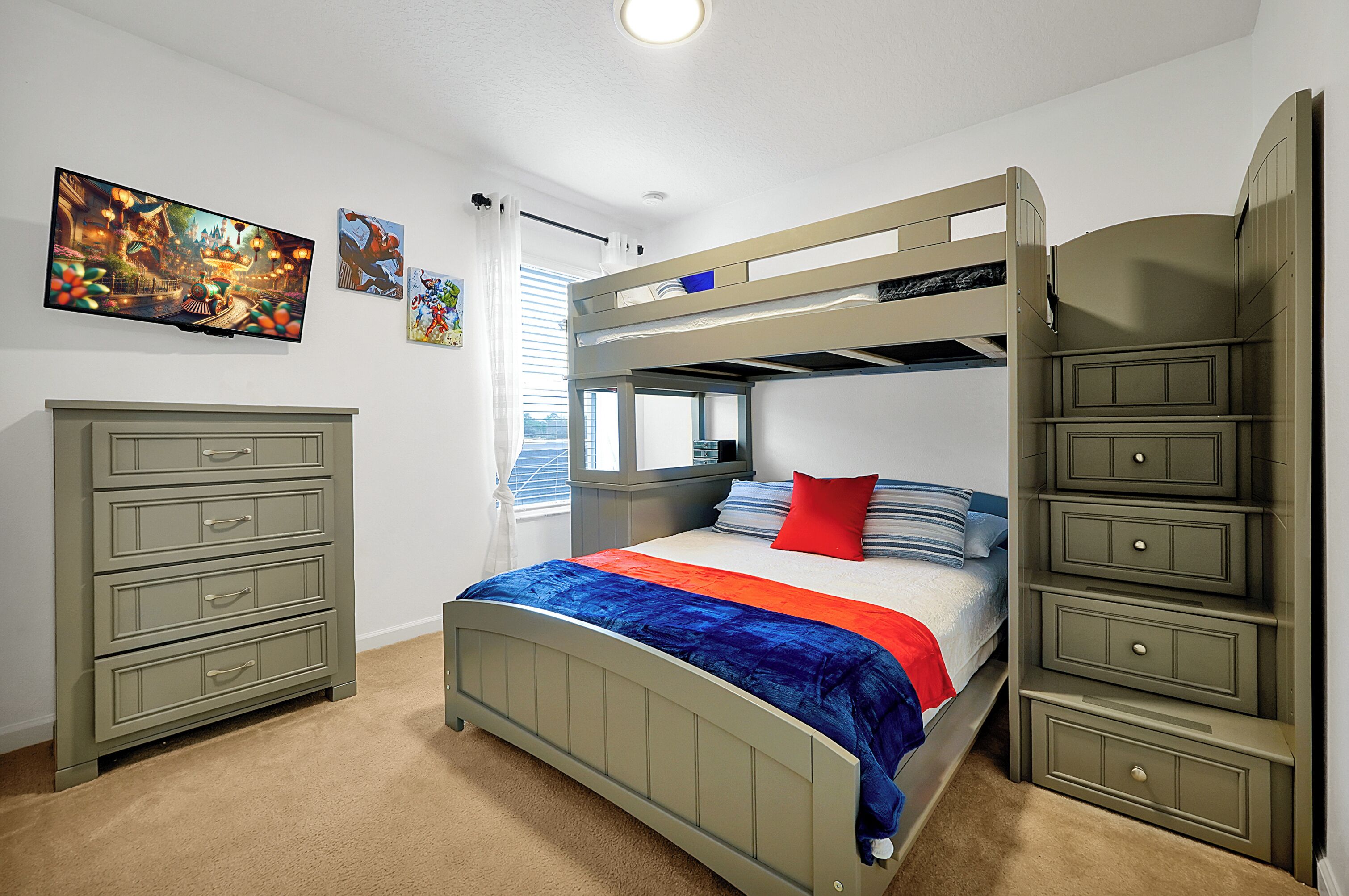 A bunk bed with a lower bunk, a dresser, and a TV on the wall.