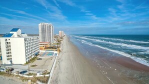 A coastal hotel with multiple buildings, a beach, and ocean views. - Three Oars Beach Surf Shack Pool, Oceanview, Game Room (Daytona Beach)