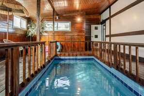 An indoor swimming pool with wooden railings and a tiled floor. - Gyeongju Palace Hanok Kids Pool Villa (Gyeongju)