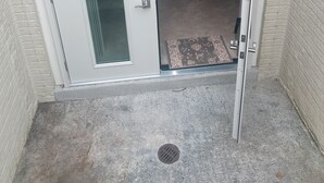 A sliding glass door leading to a covered outdoor area with a concrete floor and a doormat. - 3-bedroom apartment in Woodbridge close to shopping centers, Quantico and DC. (Woodbridge)