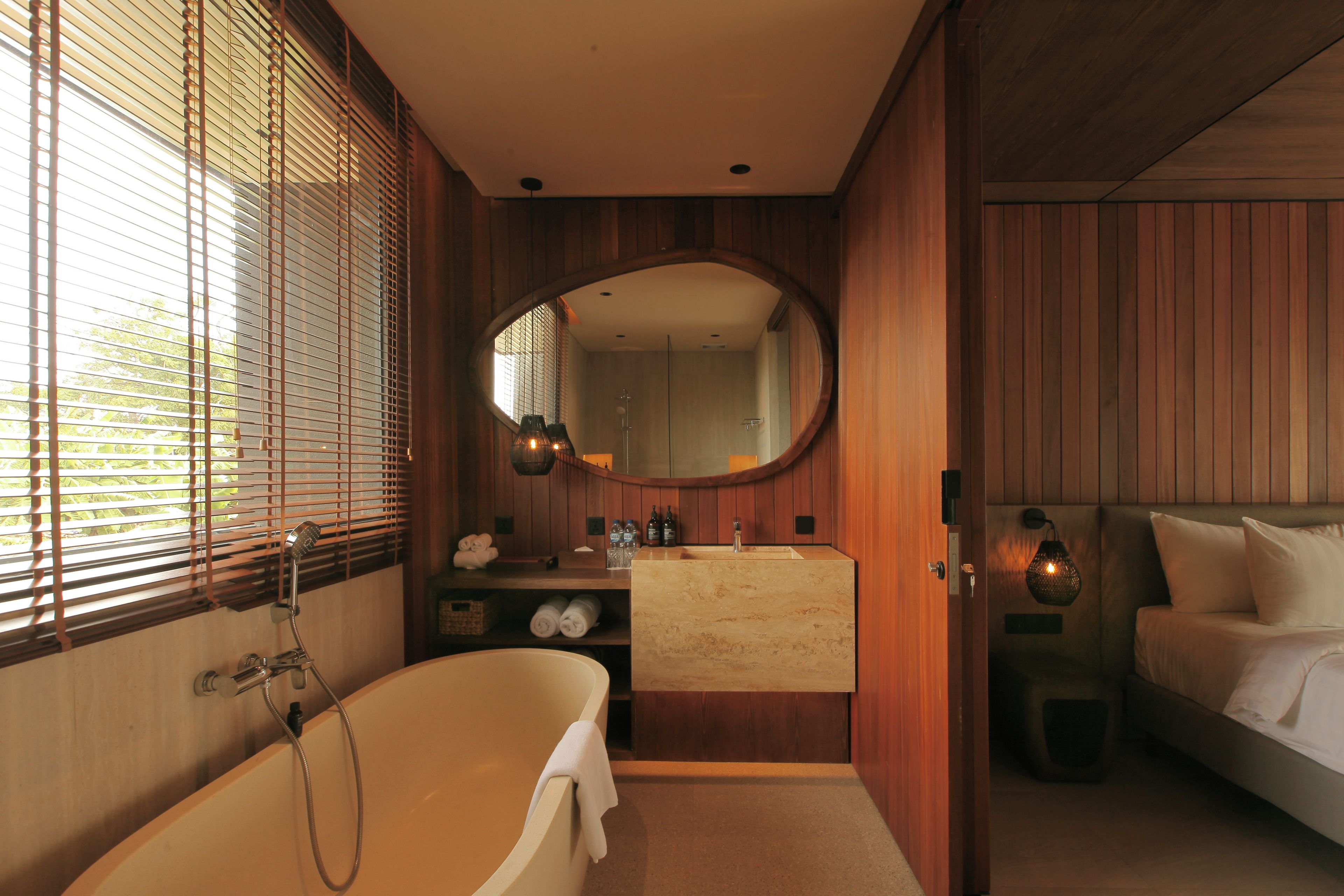 A bathroom with a bathtub, a mirror, and a sink.
