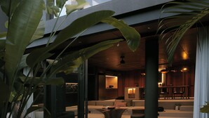 A modern interior with a pool, large windows, and indoor plants. - The Akasha Berawa Luxury Villas (Tibubeneng)