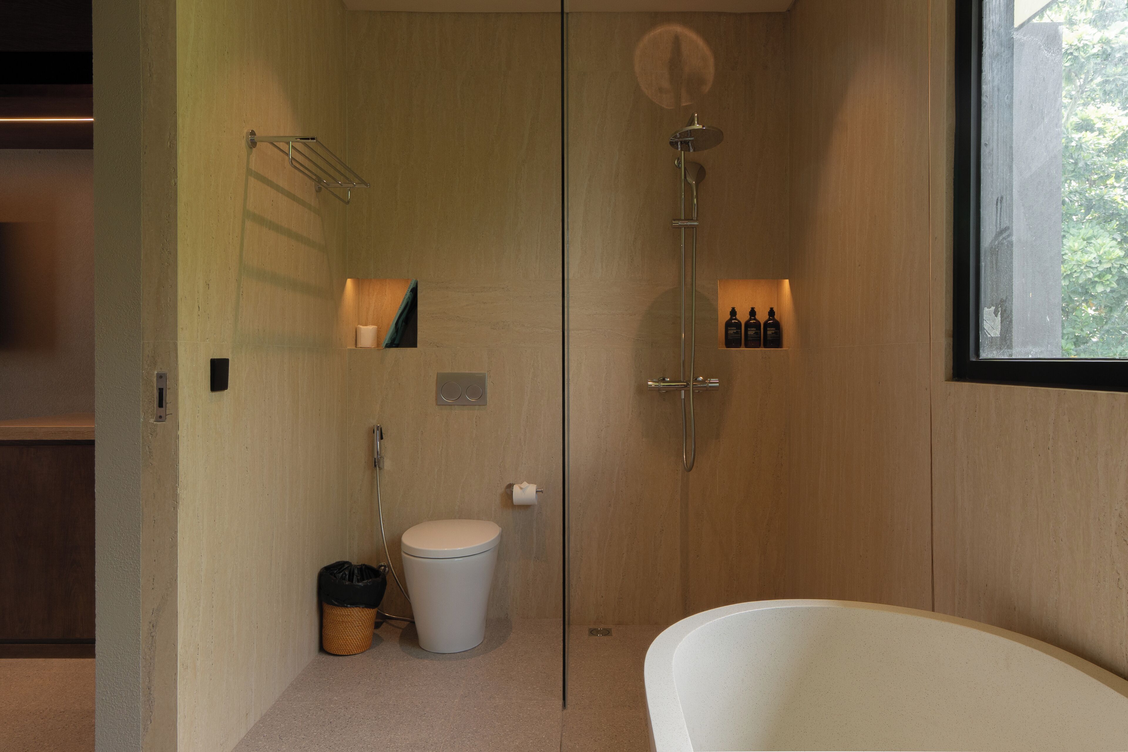 A modern bathroom with a shower, toilet, and bathtub.