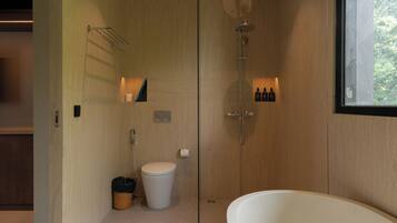 A modern bathroom with a shower, toilet, and bathtub.