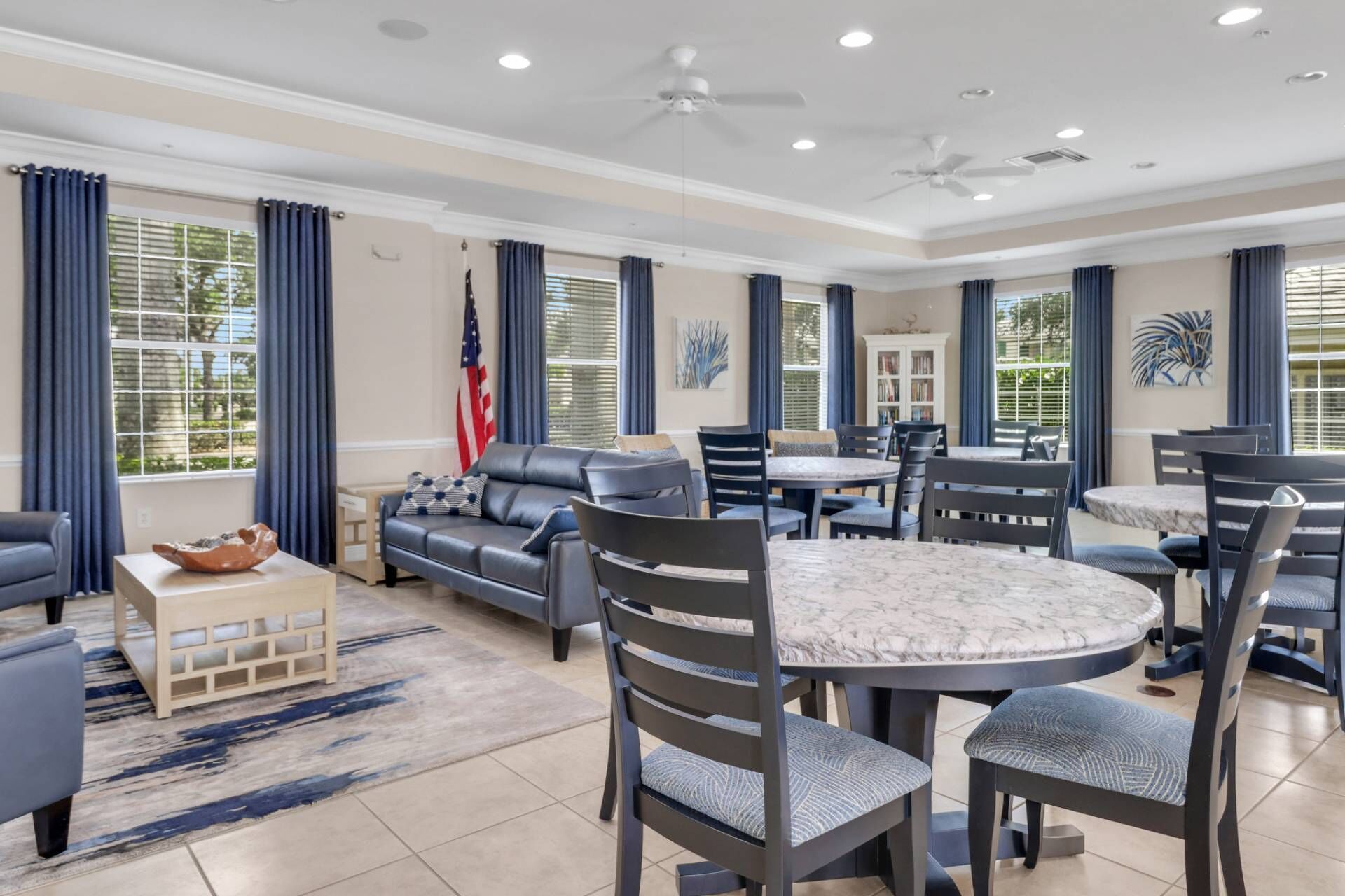 A spacious living area with a sofa, chairs, a dining table, and a coffee table.