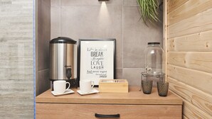 A kitchenette with a coffee maker, a framed inspirational quote, a jar, and a wooden box. - House in Međimurje for couples with jacuzzi, sauna, terrace, pool, and barbecue (Dragoslavec)