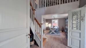 A spacious hallway with a staircase leading to a dining area. - Cozy home in Väby with WiFi (Väby)