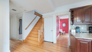 A kitchen with wooden cabinets, a granite countertop, and a stainless steel range hood. - World Cup ready. with AC, beaches, Boston, and Salem (Melrose)