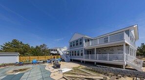 A two-story house under construction with a balcony and a staircase. - SEASIDE RETREAT - 8 bedroom semi-oceanfront with pool and ocean views (Virginia Beach)