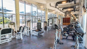 A gym with various exercise equipment, large windows, and a concrete floor. - Tulum Premium Maisonette | Jacuzzi & Cenote (Tulum)