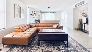 A spacious living room with a large L-shaped sectional sofa, a coffee table, and a pool table. - 5 mins to STRIP & LAS Airport, 3 King Bed 2.5 Bath, Peaceful & Clean (Las Vegas)
