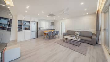 A modern living space with a kitchen, dining area, and seating area.