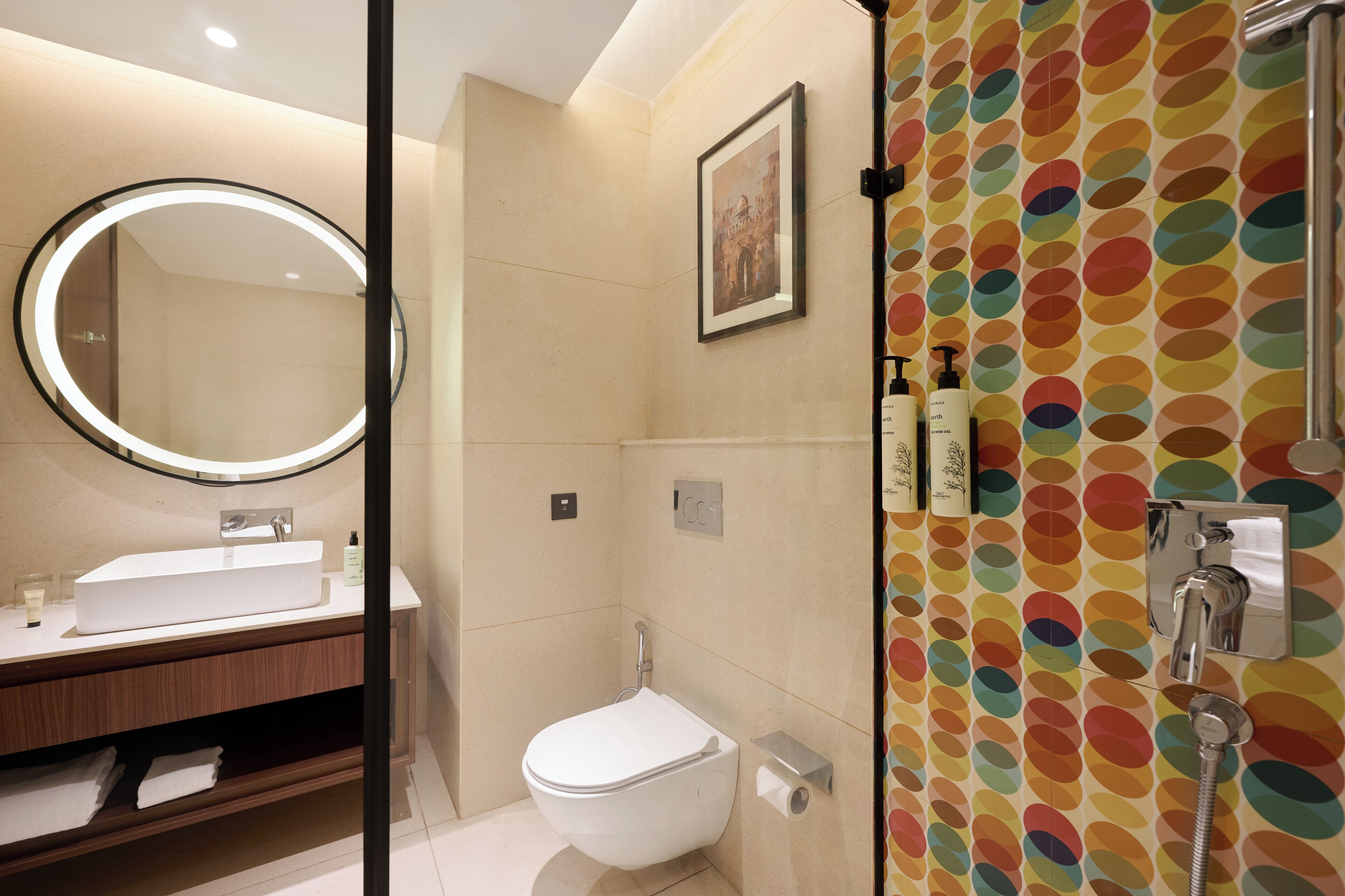 A bathroom with a white sink, mirror, toilet, and shower.