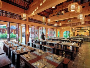 A restaurant with wooden tables and chairs, a bar area, and a view of the outdoors. - Yen Tu Village  (Yen Tu)