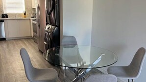 A modern kitchen with a refrigerator, stove, and sink. - Beautiful Townhome Near Sanibel (Fort Myers)
