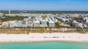 A coastal residential area with beachfront properties, a water tower, and a clear view of the ocean. - ⭐Pelican Watch-Luxury Coastal Retreat w/ 5 Balconies Nea Rosemary & Alys⭐ (Seacrest Beach)