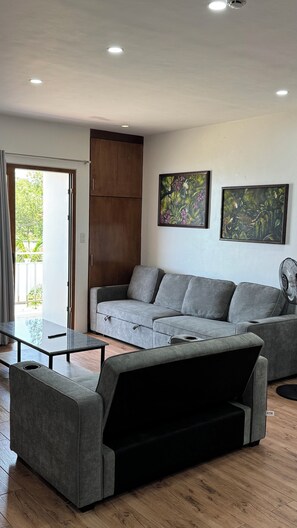 Deluxe Studio, Beach View | Living area | Smart TV, Netflix, first-run films, streaming services - buddy's Beach House Sipalay (Sipalay)