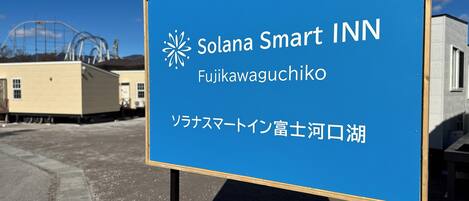 A blue signboard for Solana Smart INN in Fujikawaguchiko with Japanese text.