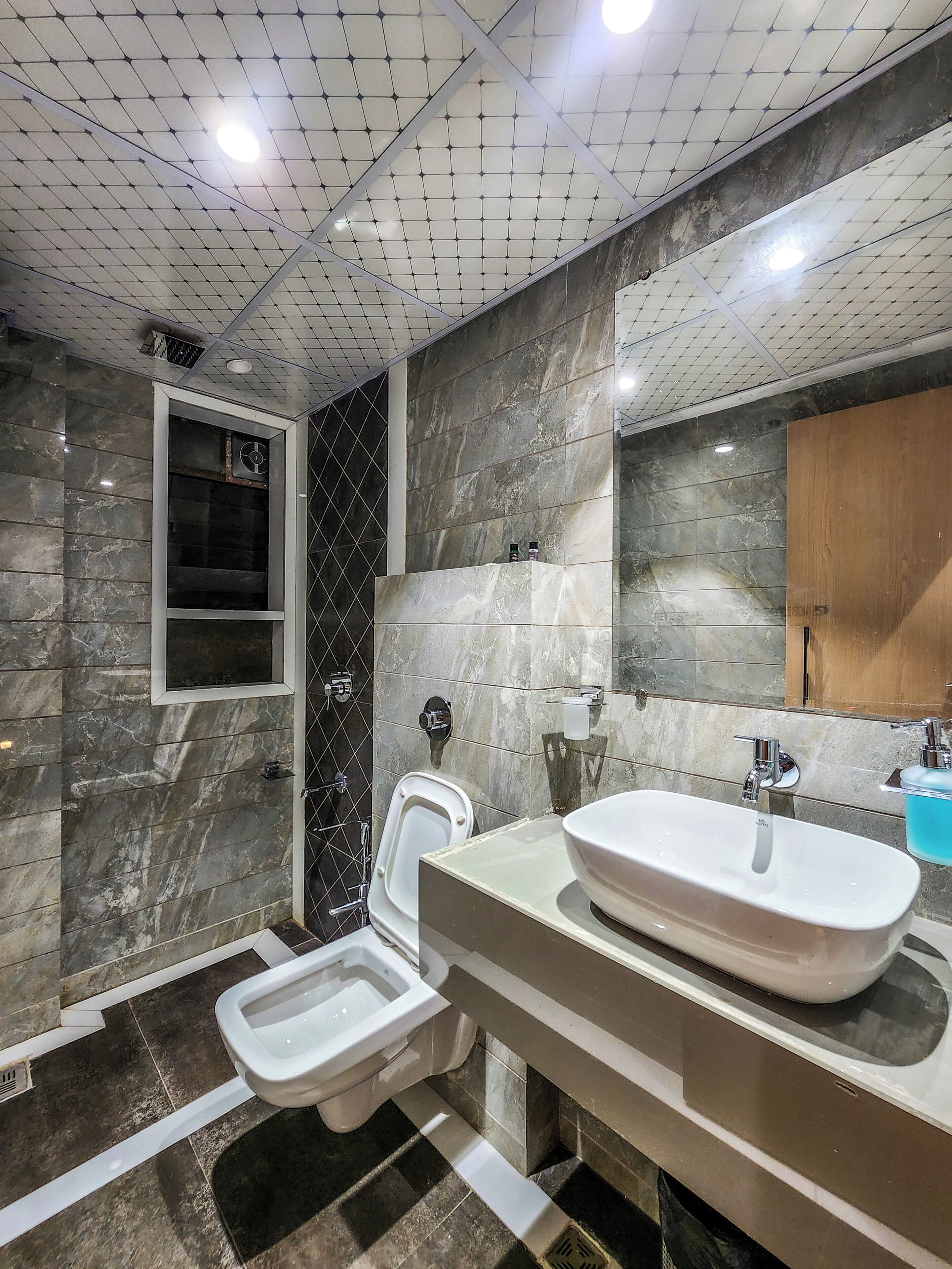 A modern bathroom with a toilet, bidet, and sink.