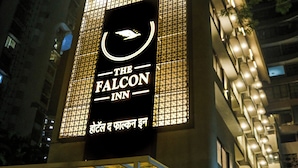 Une enseigne d’hôtel avec un logo représentant un oiseau, indiquant qu’il s’agit de « The Falcon Inn ».