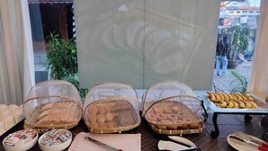 A buffet table with various baked goods and utensils. - Ahmara A Recall Value Hotel Patong, Phuket (Patong)