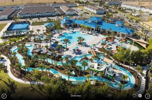 An aerial view of a resort with a large central pool, multiple smaller pools, and a variety of water slides. - 3624ll · Brand New Luxury 8BR Villa in Windsor Island (Davenport)