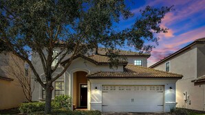A two-story house with a tiled roof, a garage, and a well-maintained lawn. - 1452 Myrtlewood, 6 Beds (Davenport)