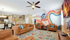 A living room with a brown sofa set, a patterned rug, and a ceiling fan. - 1452 Myrtlewood, 6 Beds (Davenport)