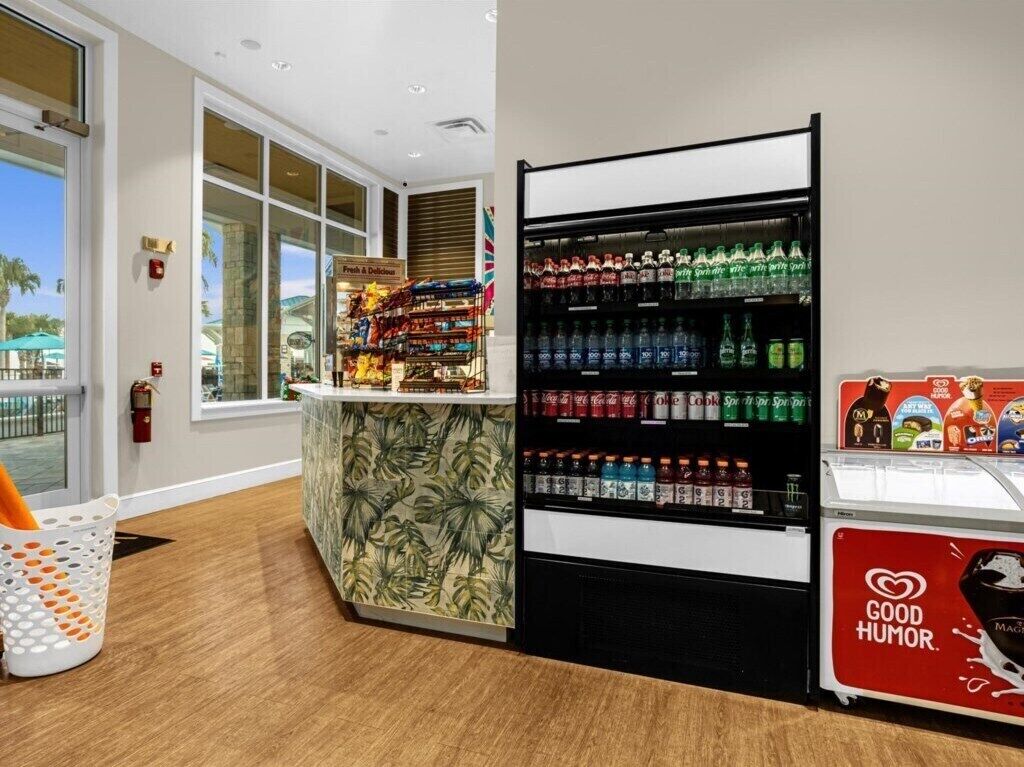 A vending machine area with various beverages and a small ice cream display.