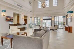 A spacious lobby with a reception desk, seating area, and a Game Room sign. - 8814 Geneve CT, Kissimmee, 4 BED (Kissimmee)