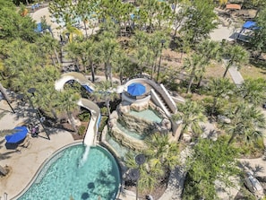 An aerial view of a resort with a large pool, water slides, and palm trees. - 4159-5-ot-contemporary Resort Villa (Davenport)