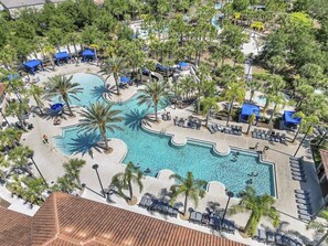 A resort pool area with multiple pools, palm trees, and lounge chairs. - 4159-5-ot-contemporary Resort Villa (Davenport)