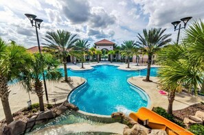 A swimming pool with multiple lanes, surrounded by palm trees and a building with a red-tiled roof in the background. - 4159-5-ot-contemporary Resort Villa (Davenport)