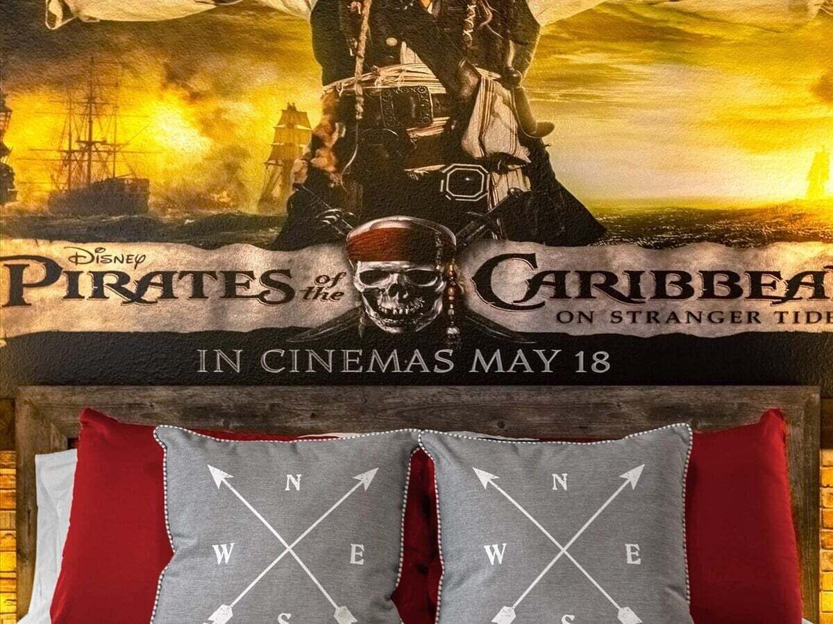 A promotional poster for 'Pirates of the Caribbean: On Stranger Tides' with a skull and pirate-themed imagery.