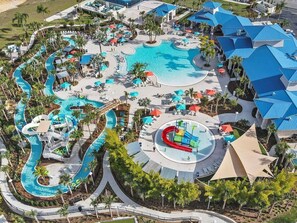 An aerial view of a resort with a large central pool, multiple water slides, and a variety of outdoor seating areas. - 1891sd · Brand New 7br/pool/spa/ Disney Fireworks View (Davenport)