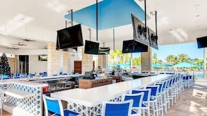 A bar area with multiple seating arrangements, a fireplace, and a television. - 1891sd · Brand New 7br/pool/spa/ Disney Fireworks View (Davenport)