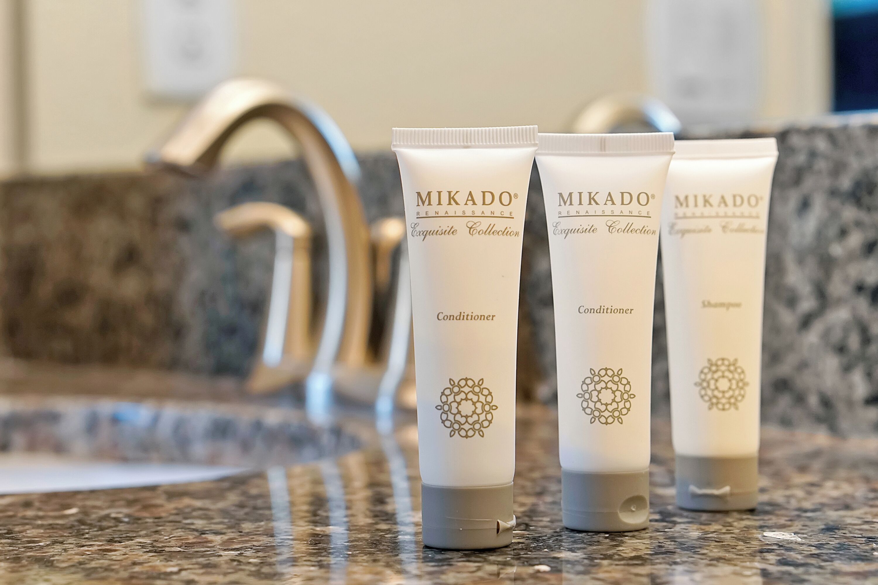 Three Mikado Renaissance Exquisite Collection tubes on a granite countertop.
